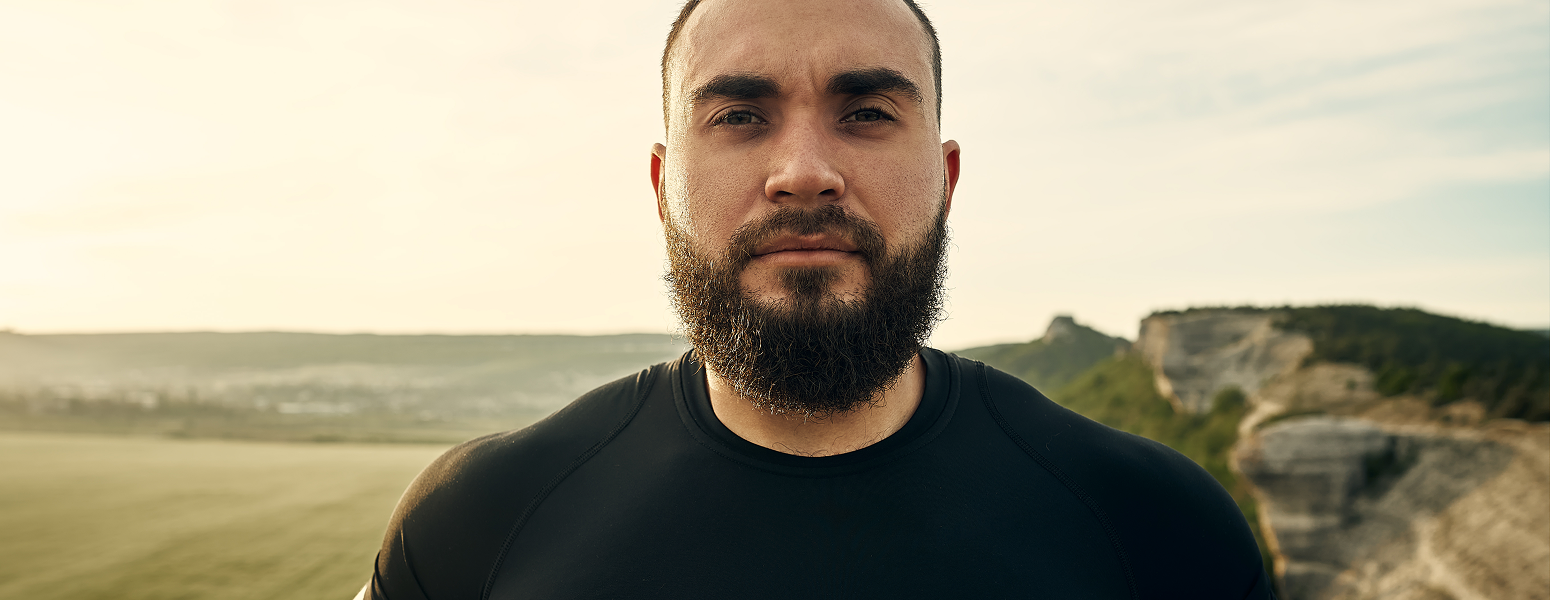 a beared man looking into the camera