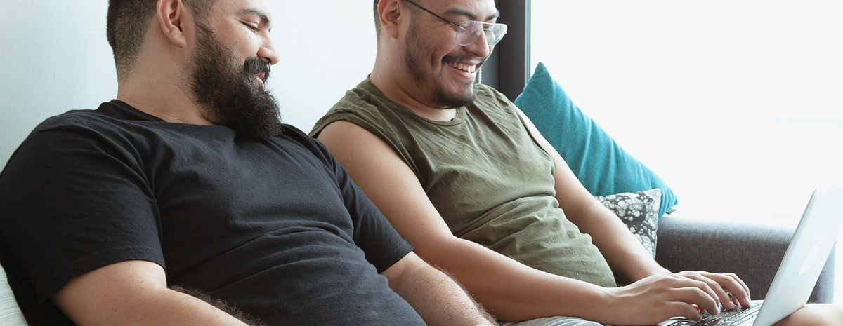 Two men looking at a laptop