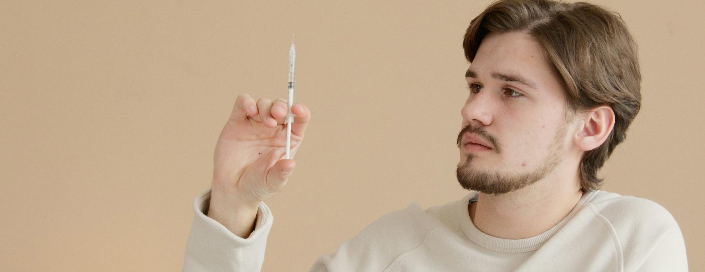 a man holding a syringe