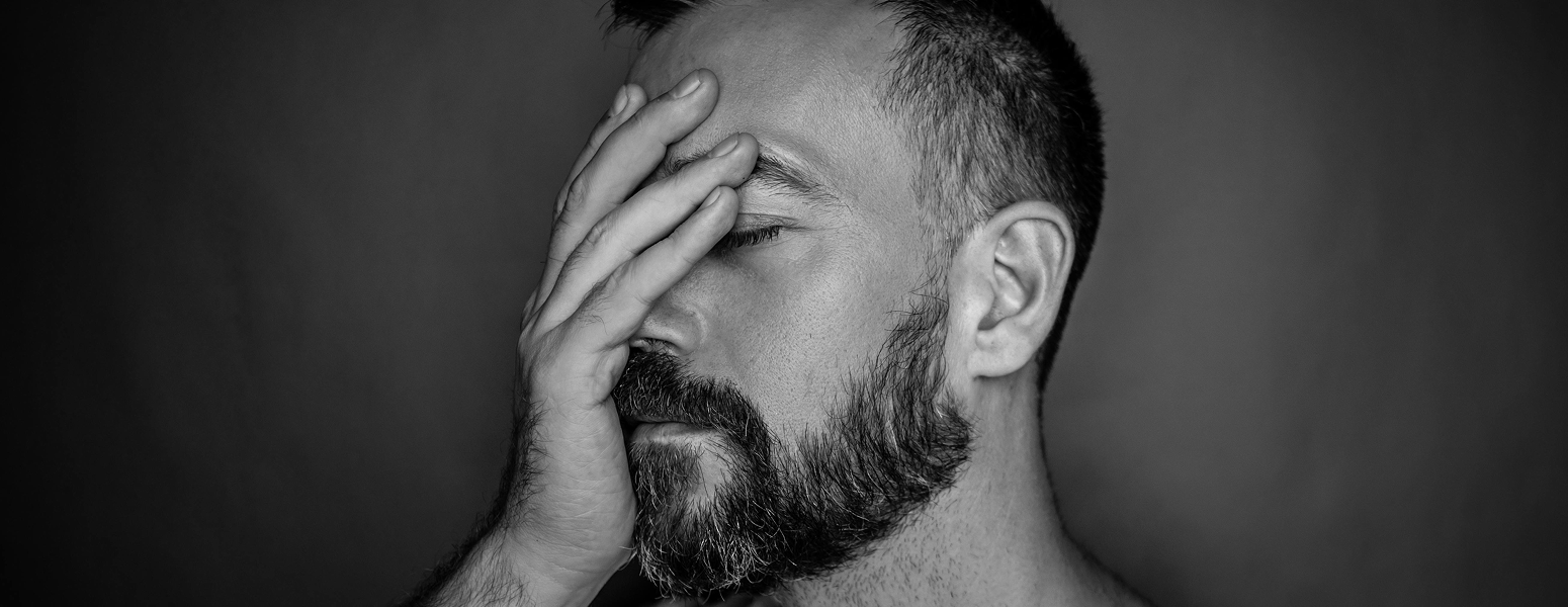 Black and white image of a man looking worried
