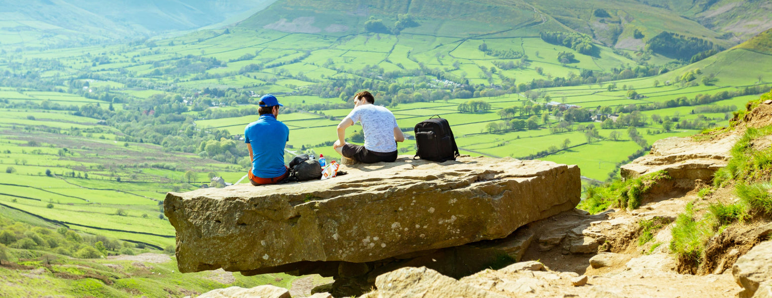 Three men sitting on a rock
